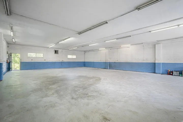 Spacious interior with concrete flooring and multiple windows