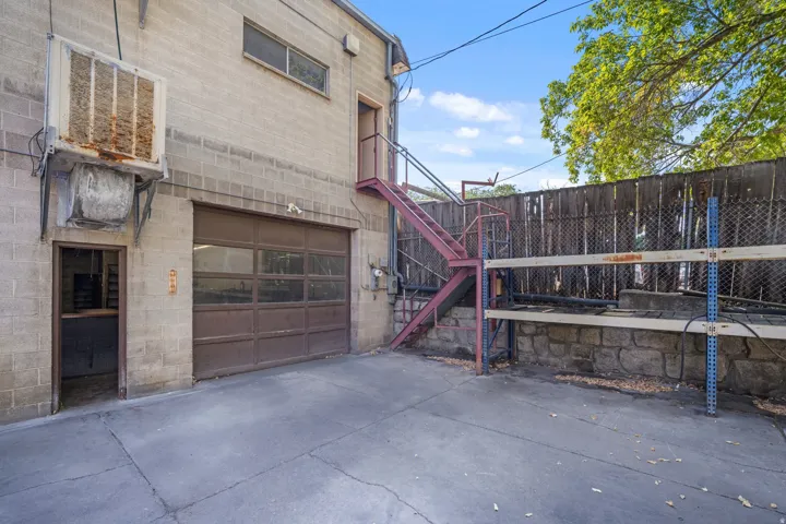 Concrete paving leading to a garage door with clear panels