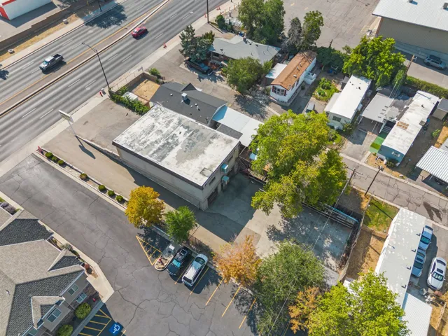 Commercial building with a flat roof, adjacent parking, and mature trees