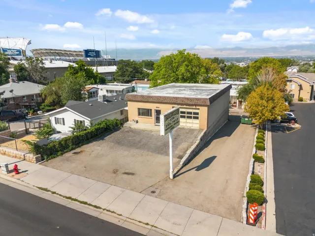 Building with a flat roof, brick exterior, and roll-up garage door