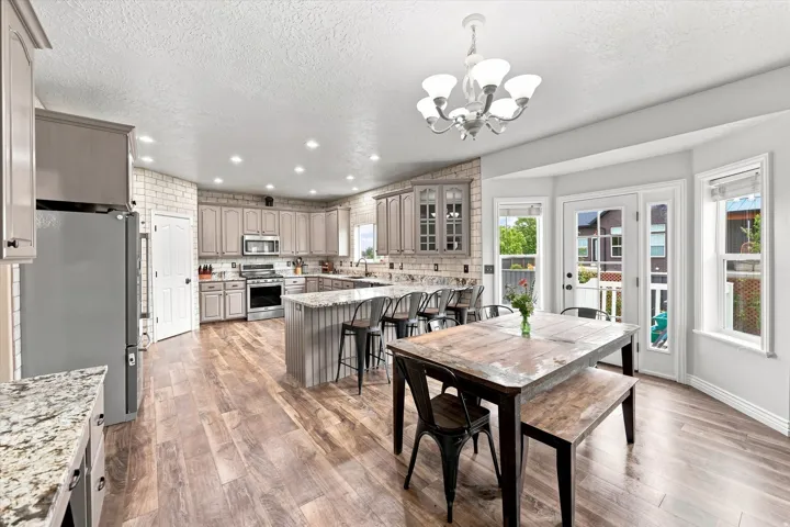 Kitchen featuring wood-finish flooring, recessed lighting, and a kitchen island with seating
