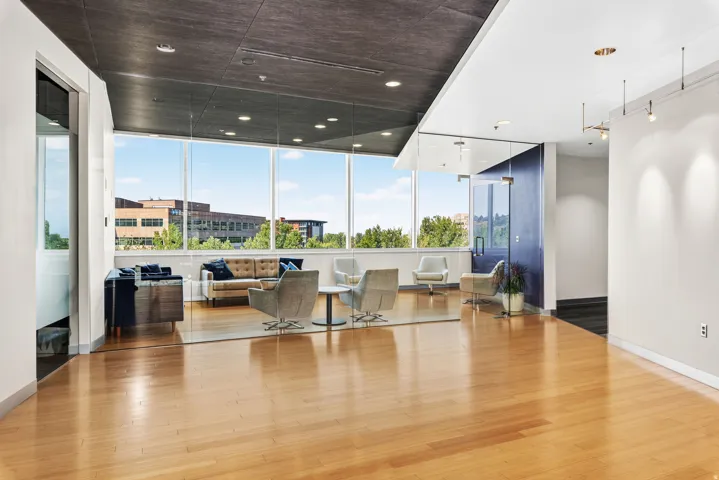 Expansive windows, hardwood flooring, and recessed lighting