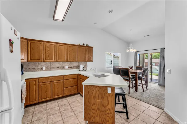 Kitchen featuring wood cabinetry, light countertops, and tile flooring