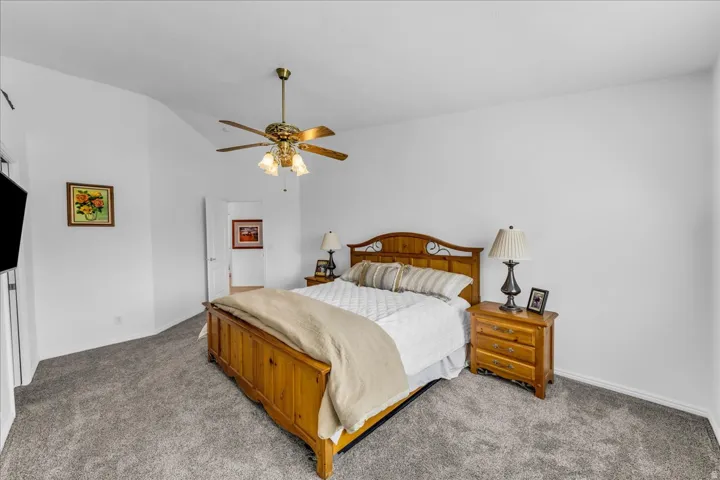 Vaulted ceiling featuring a brass-finish ceiling fan with integrated lighting