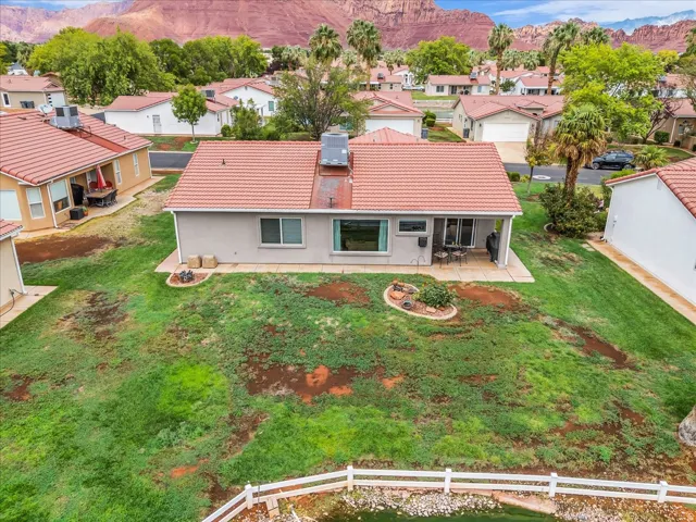 Rear patio with a privacy wall and a red tile roof