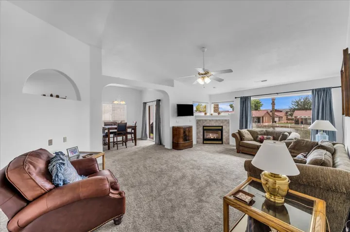Arched doorways, vaulted ceilings, and a built-in fireplace with a stone surround