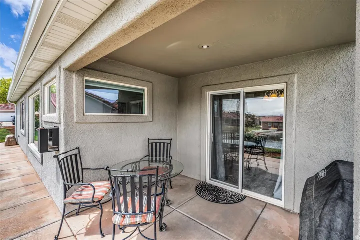 Covered patio with recessed lighting and a sliding glass door