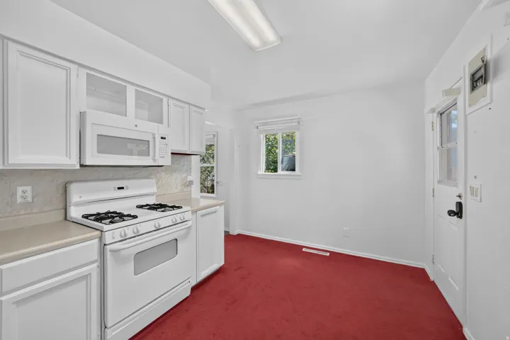 White cabinetry with glass-front accents