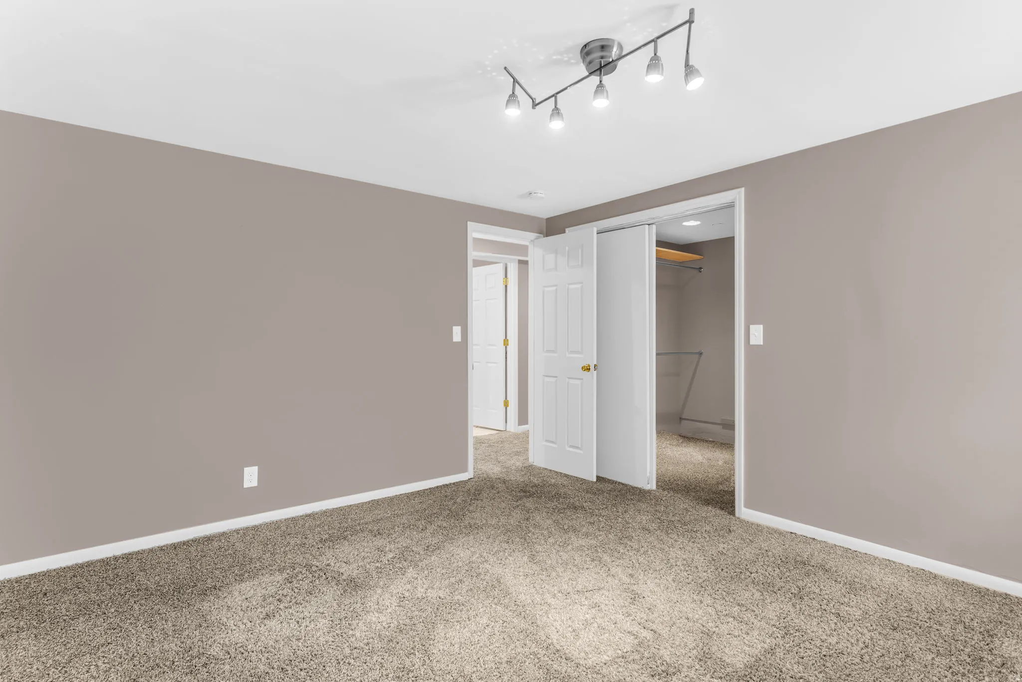 Neutral-toned walls complement plush carpeting