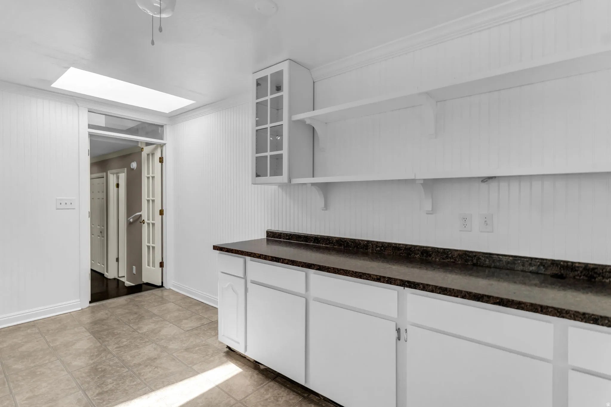 White cabinetry with dark-toned countertops