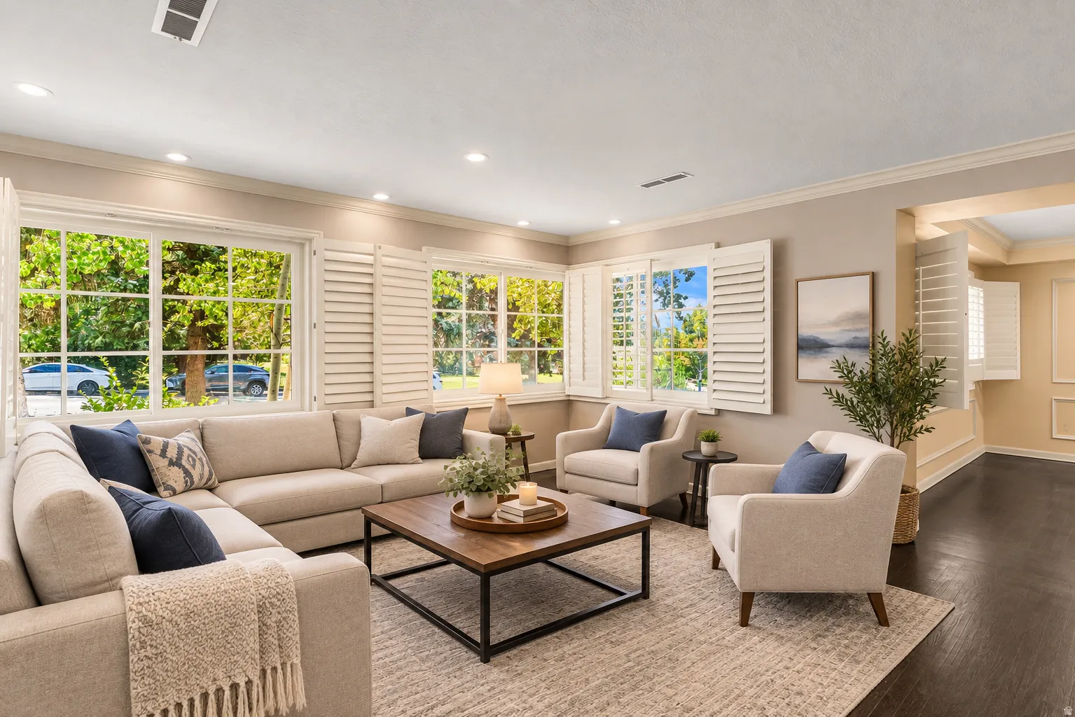 Dark wood-finish flooring, recessed lighting, and crown molding
