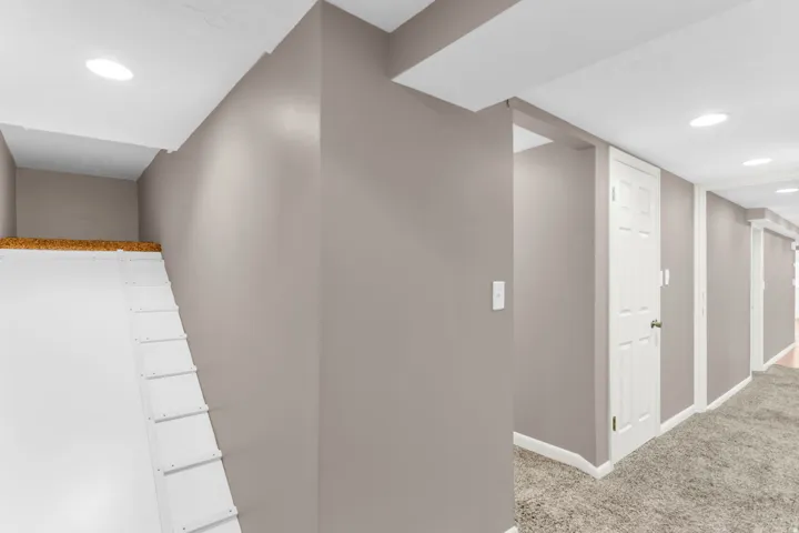 Recessed ceiling lighting, white trim, paneled interior doors, and neutral wall paint