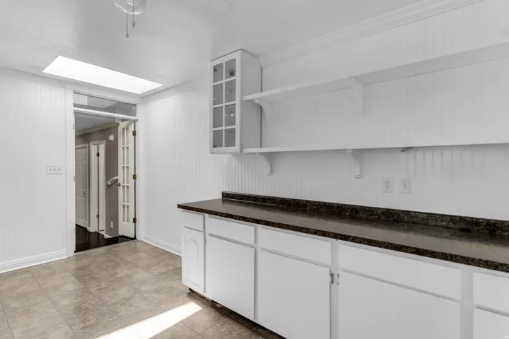 White cabinetry with dark-toned countertops