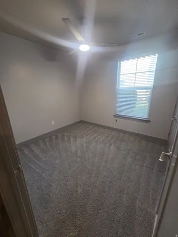 Recessed window with blinds, ceiling-mounted fan with integrated lighting, and wall-to-wall carpeting