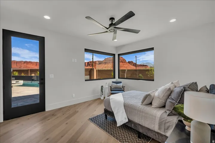 Wood-finish flooring, recessed lighting, and a contemporary ceiling fan