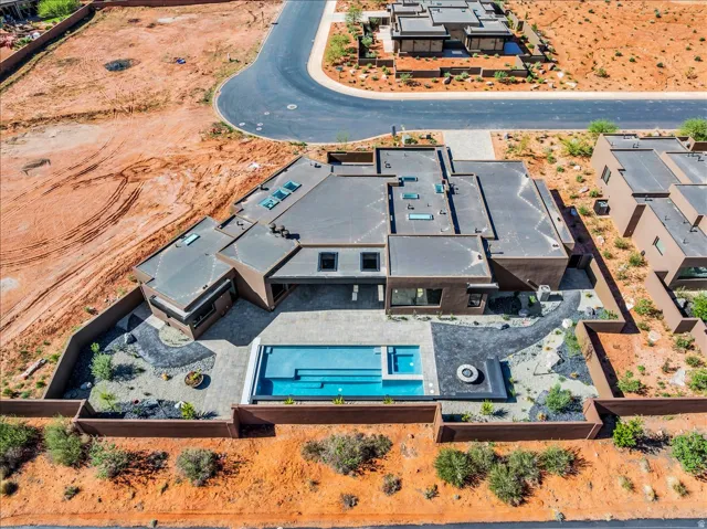 Contemporary residence featuring a flat roofline, multiple skylights, and a private swimming pool