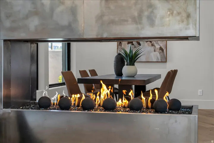 Modern linear fireplace with a stainless steel surround, black fire glass, and decorative fire balls