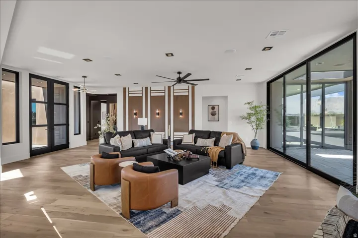 Spacious room with wood-finish flooring, recessed lighting, and a ceiling fan