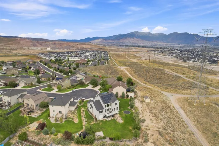 Expansive residential area with scattered homes and mountainous terrain