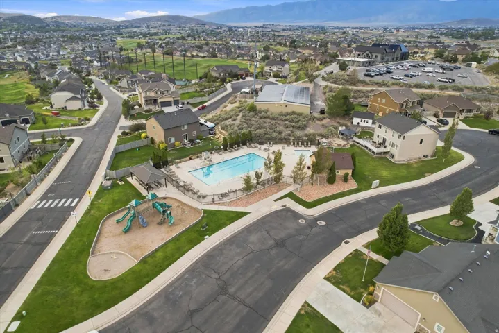 Community amenities featuring a swimming pool, playground, and shaded seating area