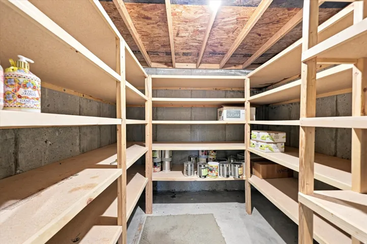Expansive wood shelving system with multiple tiers, concrete walls, and overhead lighting