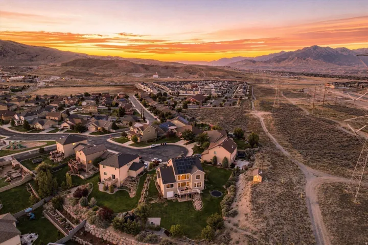 Expansive lot with tiered landscaping, a spacious back deck, and solar panels