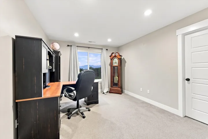 Recessed lighting, light-toned walls, and carpet flooring