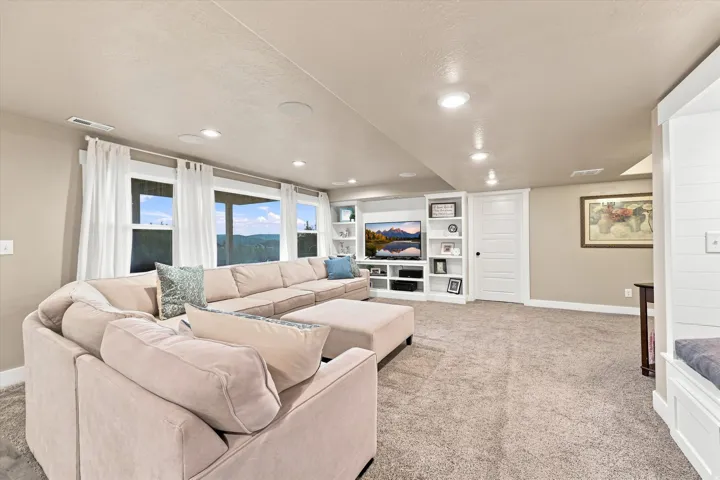 Integrated built-in shelving, recessed lighting, and a window bench with shiplap detailing