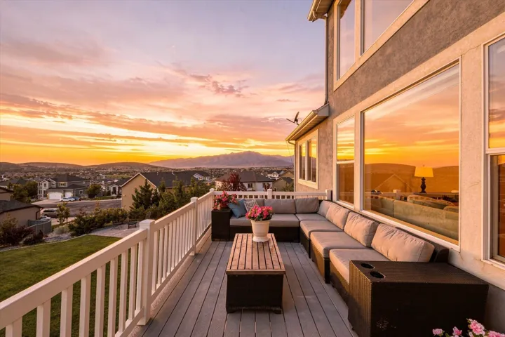 Expansive elevated deck with a white railing system, featuring a gray composite surface