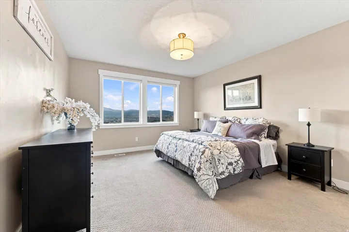 Carpeted bedroom with a multi-pane window and a built-in light fixture