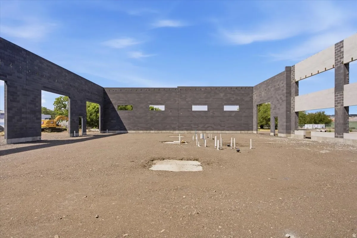 Masonry block wall construction with multiple framed openings and exposed plumbing rough-ins