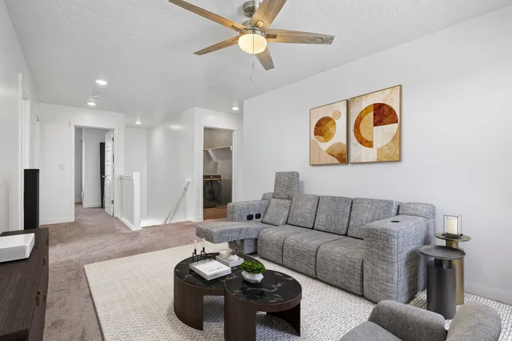 Recessed lighting illuminates the space, complemented by a ceiling fan