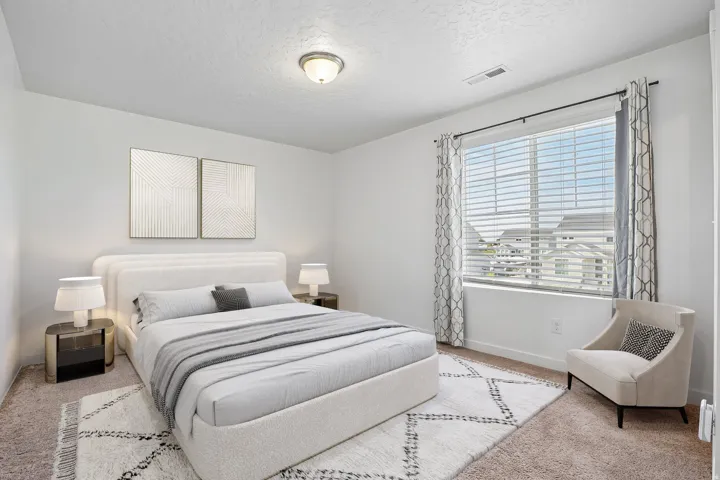 Wall-to-wall carpeting with a bright window and mounted ceiling light fixture