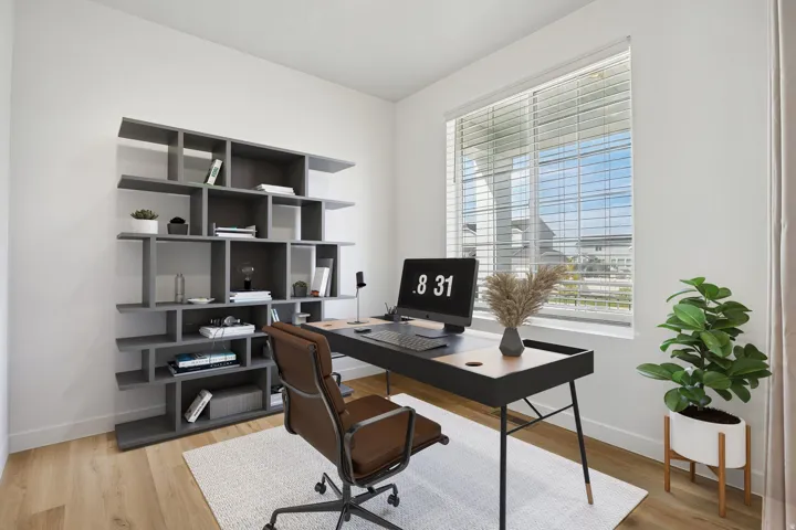 Spacious room with light wood-finish flooring, a large window, and a built-in shelving unit