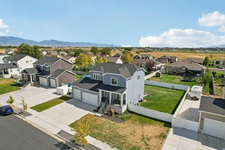Modern two-story residence featuring a clean-lined exterior with mixed siding materials, double-car garage with concrete driveway, and manicured front lawn