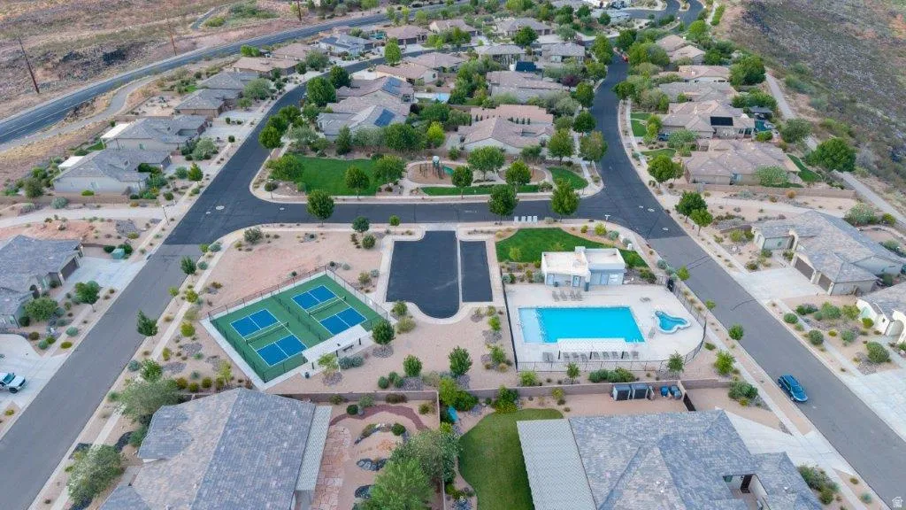 Community amenities featuring a swimming pool, shaded pool deck, and multiple sports courts