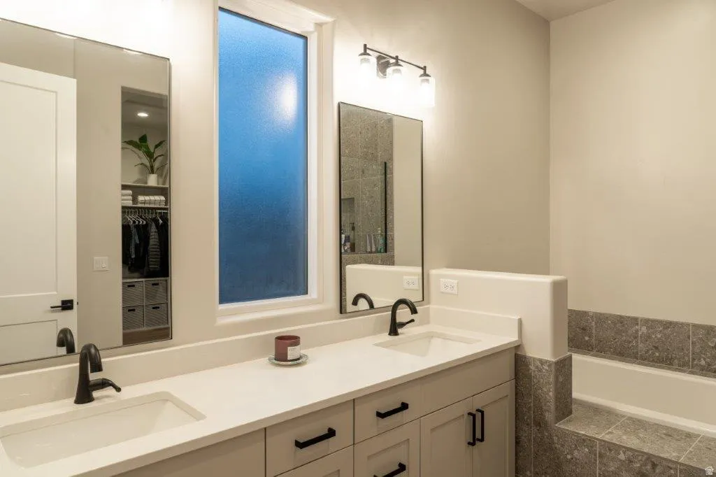 Dual vanity with integrated sinks, matte black fixtures, and light-toned countertops