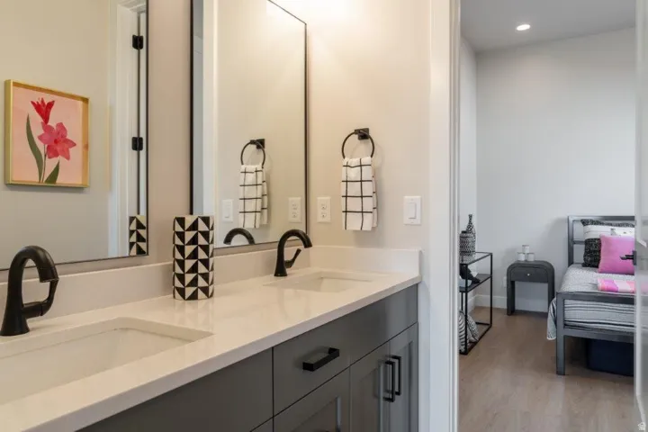 Dual vanity with integrated sinks, light-toned countertop, and dark-finish faucets