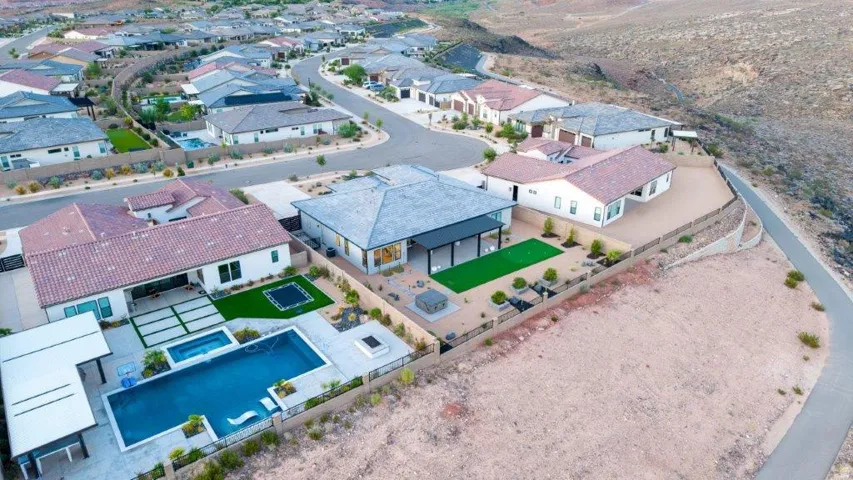 Expansive backyard featuring a rectangular pool, integrated spa, fire pit, and a covered patio structure