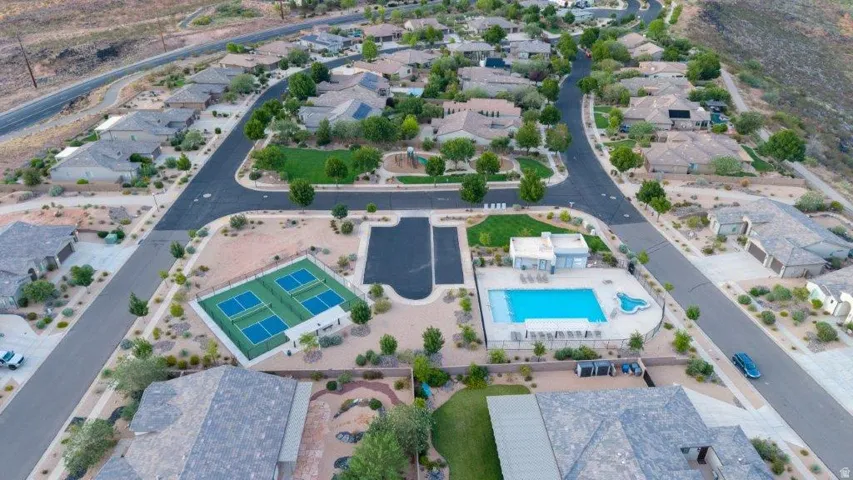Community amenities featuring a swimming pool, shaded pool deck, and multiple sports courts