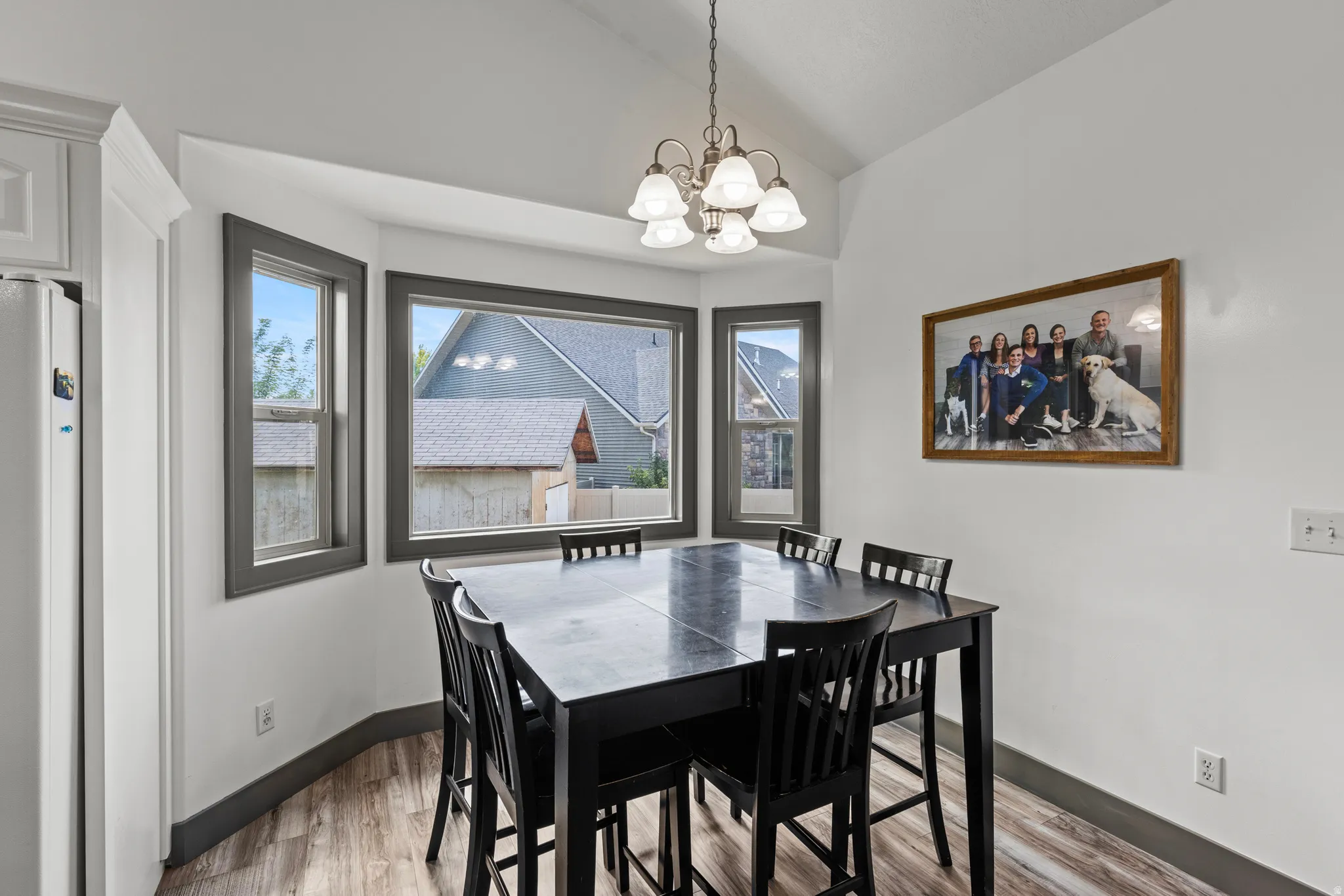 Vaulted ceiling with an attached chandelier.