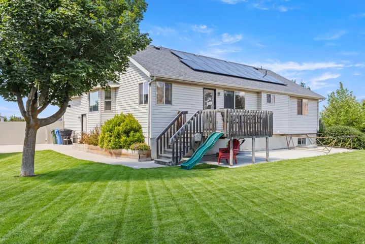 Home with vinyl siding and an updated roof featuring solar panels