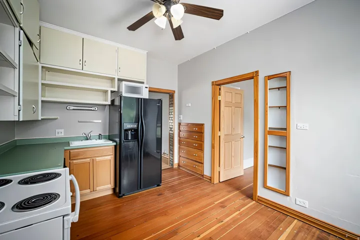 Wood-finish flooring, built-in shelving, wood door frames, ceiling fan