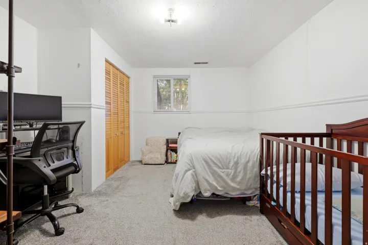 Wall-to-wall carpeting and white walls with chair rail detailing