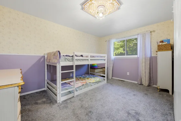Recessed window with white trim, wall-to-wall carpeting, and a ceiling-mounted light fixture