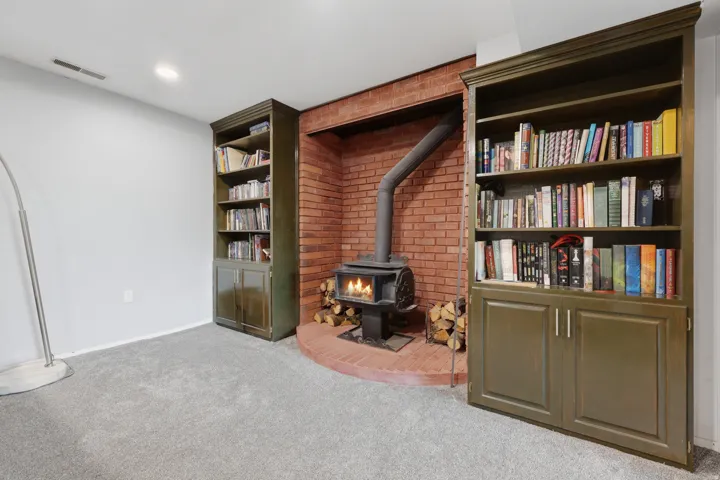 Brick fireplace with wood-burning stove and a brick hearth