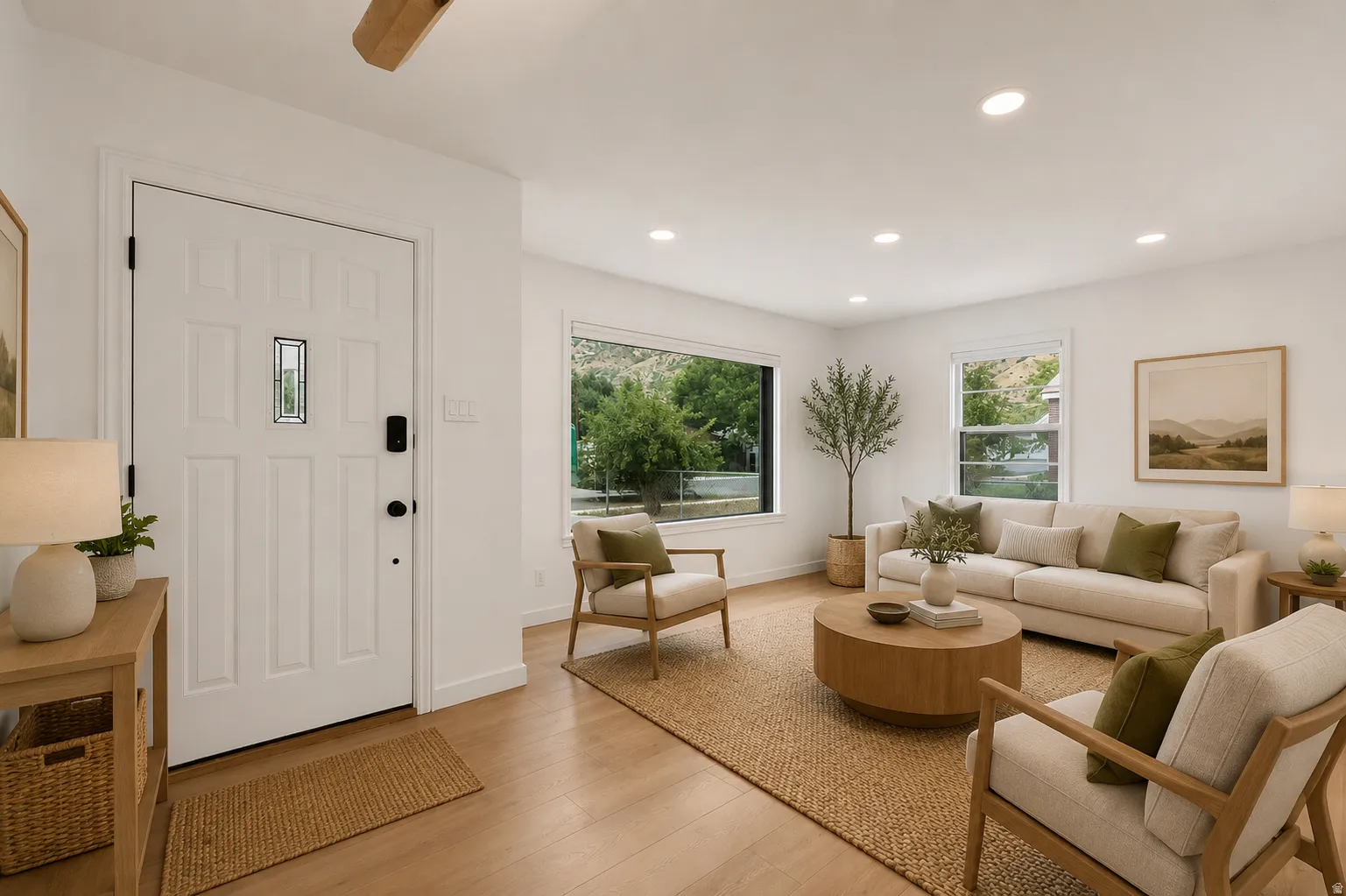 Recessed lighting, wood-finish flooring, white paneled entry door with decorative glass inlay, and multiple windows