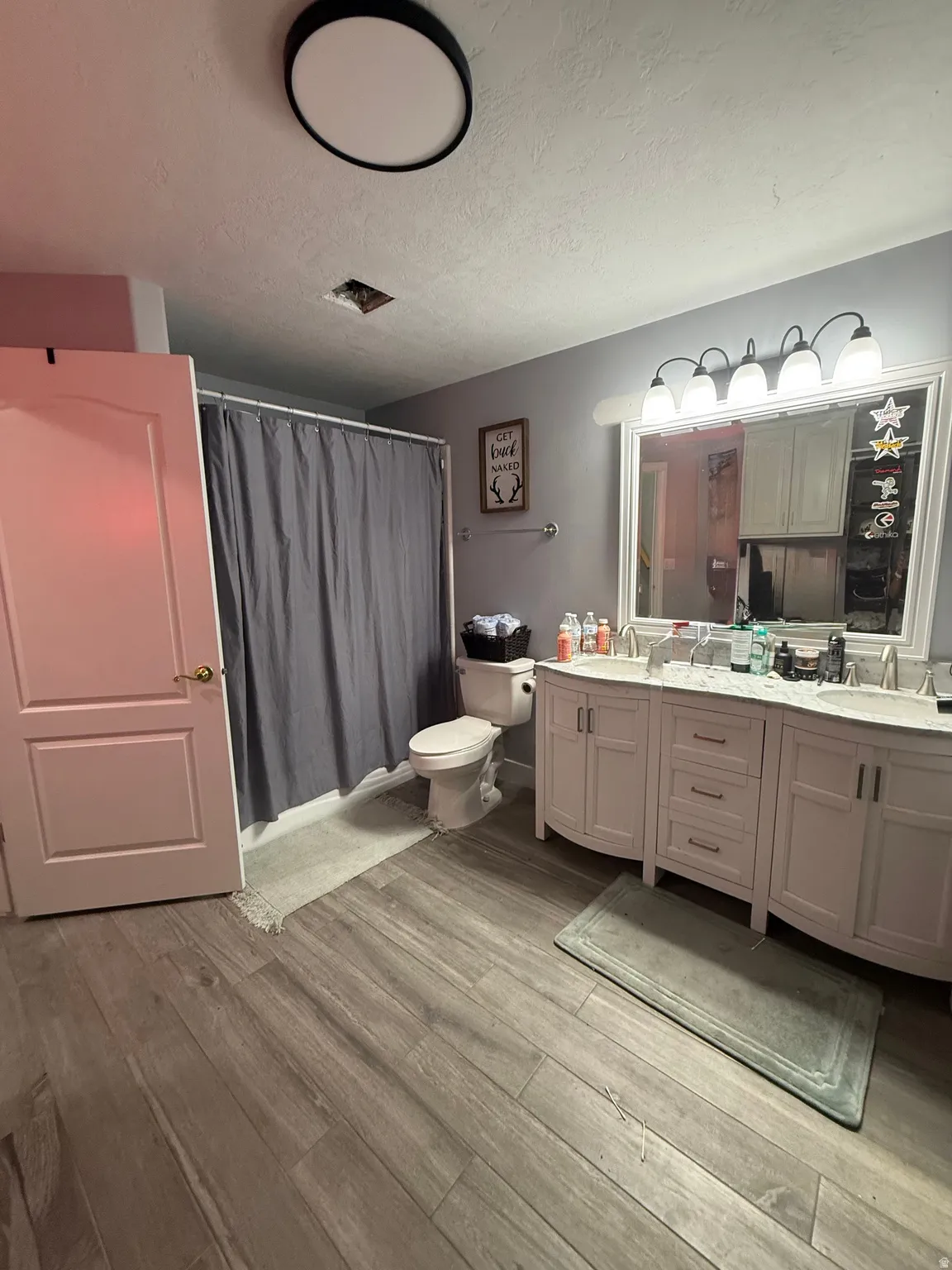 Dual vanity with white cabinetry, light-colored countertops, and undermount sinks