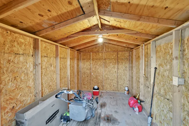 Exposed wood framing and oriented strand board walls, plywood flooring, light and outlets
