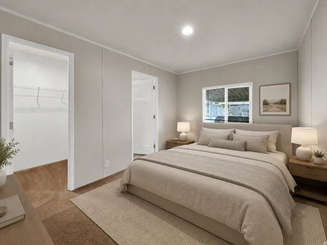 Serene primary bedroom showcasing neutral taupe walls, recessed ceiling lighting, and dual nightstands with integrated table lamps